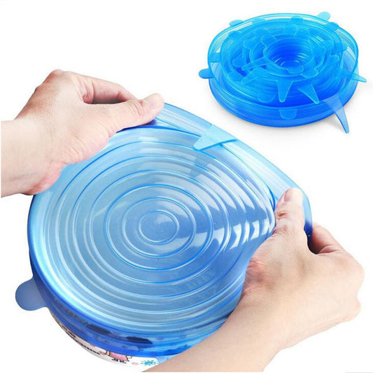 Blue silicone lid being stretched over a container by hands on a white background