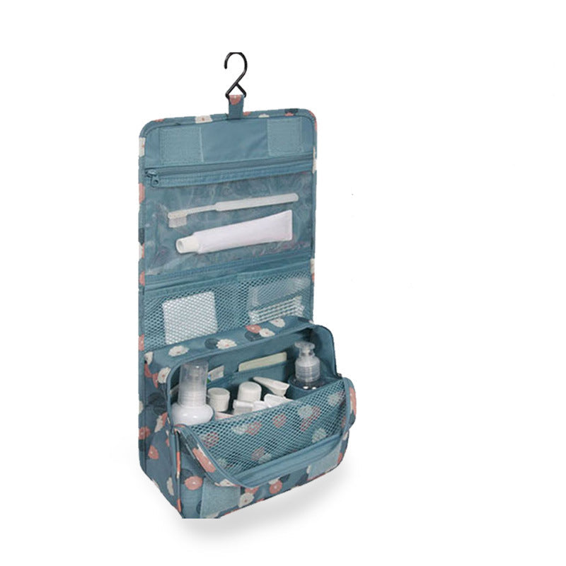 Blue hanging toiletry bag with cosmetic items on a white background