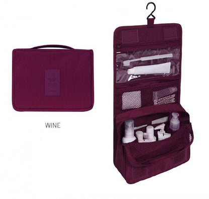 Wine-colored travel toiletry bag with products inside on a white background