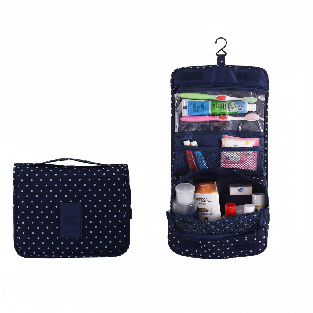 Navy blue toiletry bag with white polka dots containing travel-sized products on a white background.