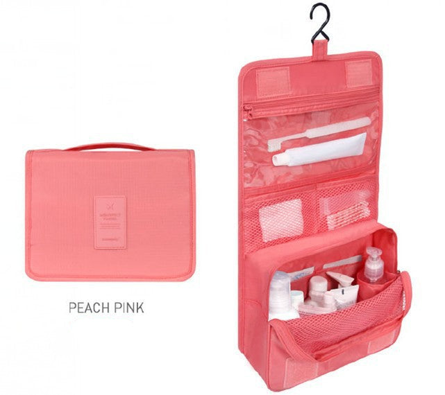 Pink travel organizer with toiletries on a white background