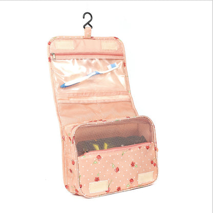 Pink hanging toiletry bag with floral pattern on a white background