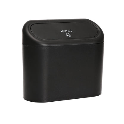 Black trash bin with push lid on a white background