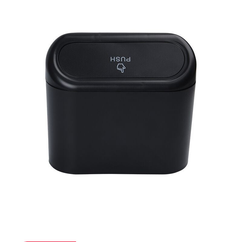 Black trash can with push lid on a white background