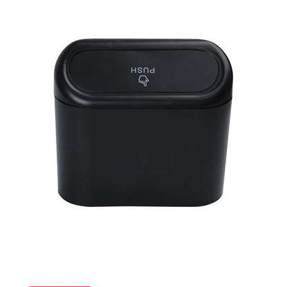 Black trash can with push lid on a white background