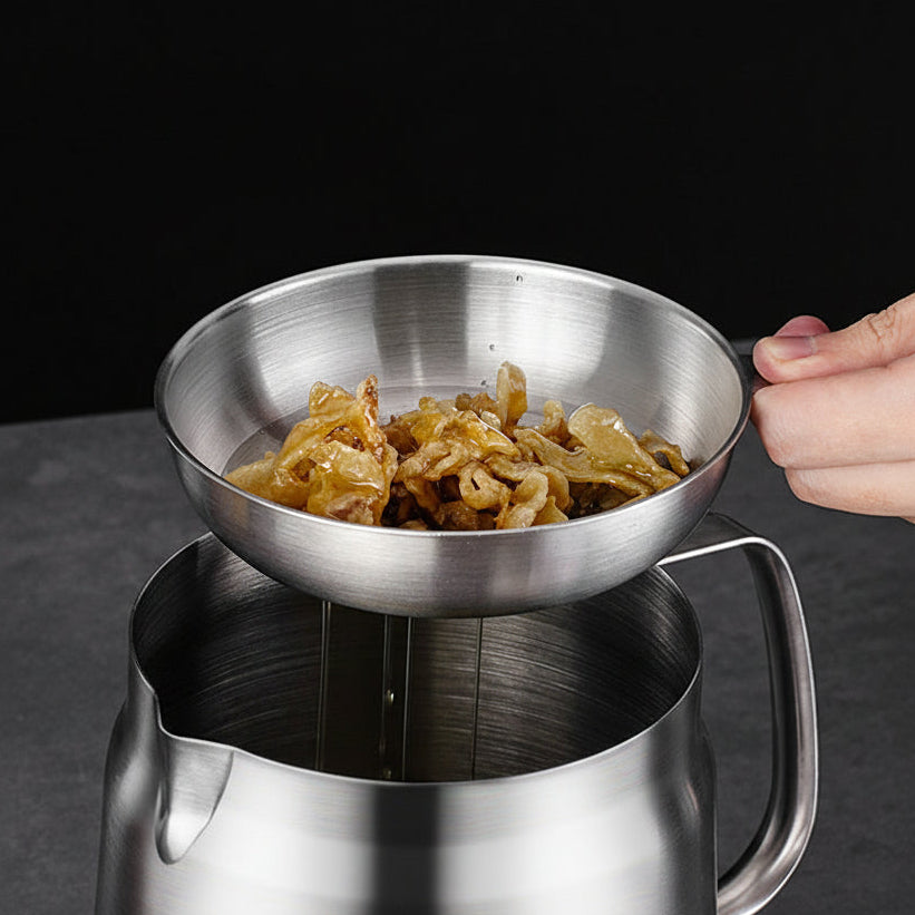Stainless steel strainer with food being used over a pot, on a dark background.