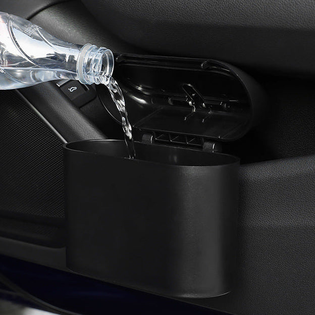 Car cup holder with water being poured into it, showing its capacity and design.